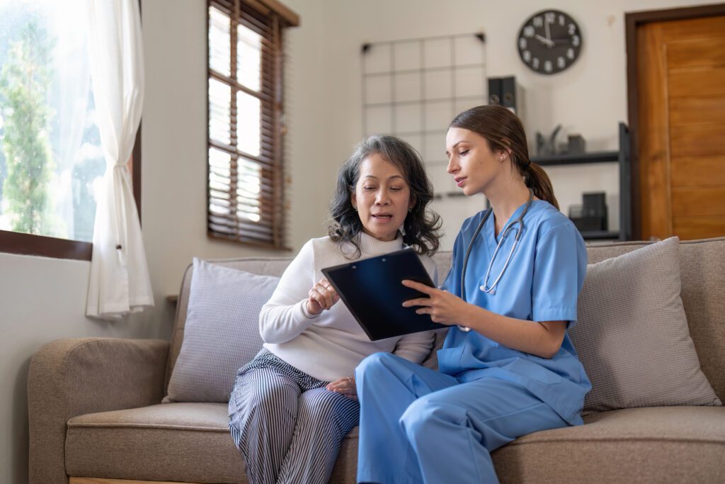 Nurse taking notes during home visit with senior f 2023 02 11 05 48 49 utc